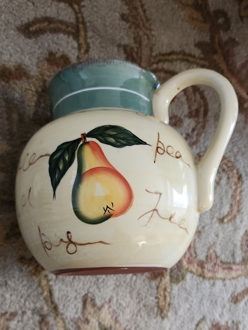 Hand Crafted Cream Ceramic Pitcher with Pear Motif and Green Rim